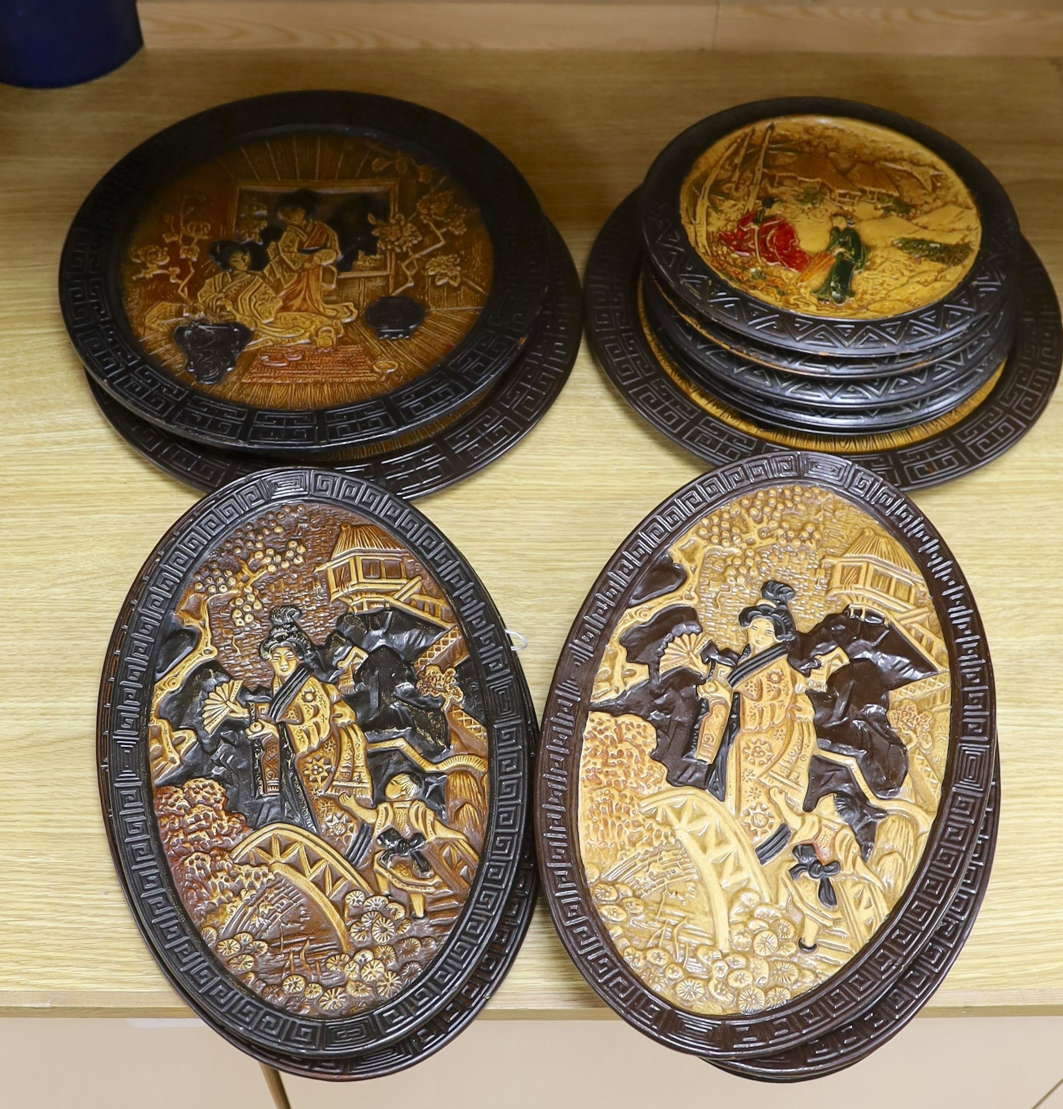 A collection of 13 Bretby chinoiserie wall plaques, largest 35cm diameter